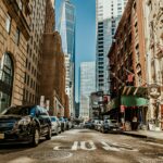 vehicles-on-road-between-buildings-1389339